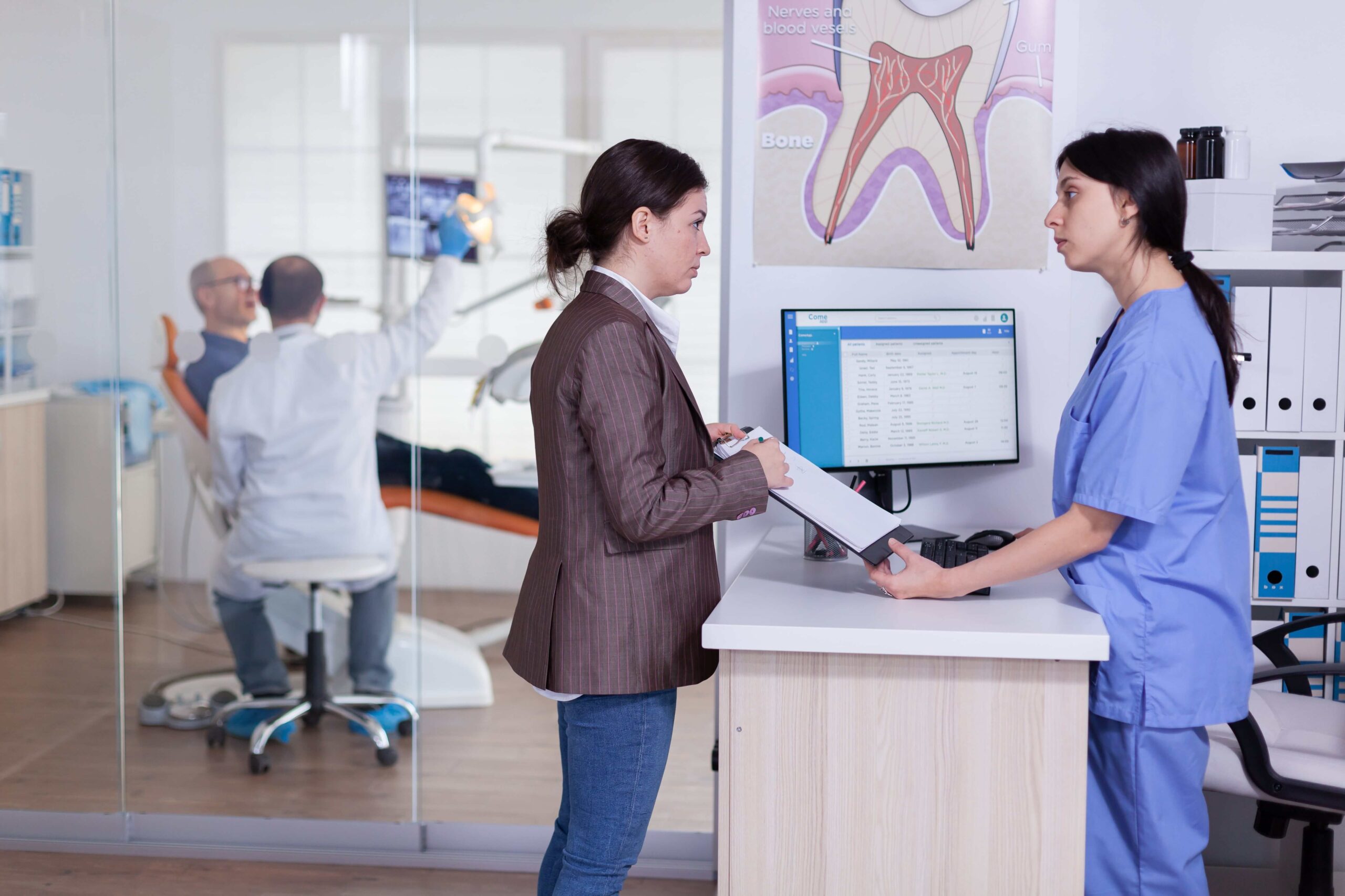 woman filling out insurance form in a dental clinic