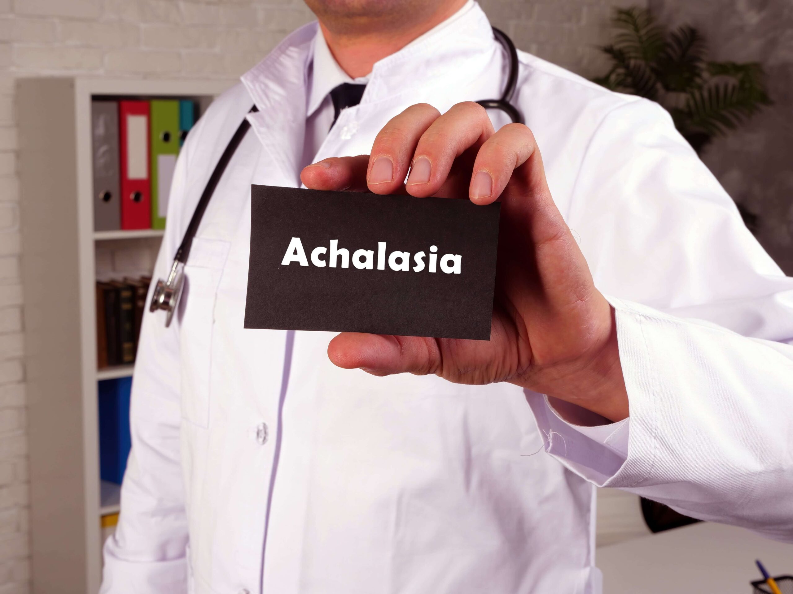 doctor holding paper with achalasia written on it