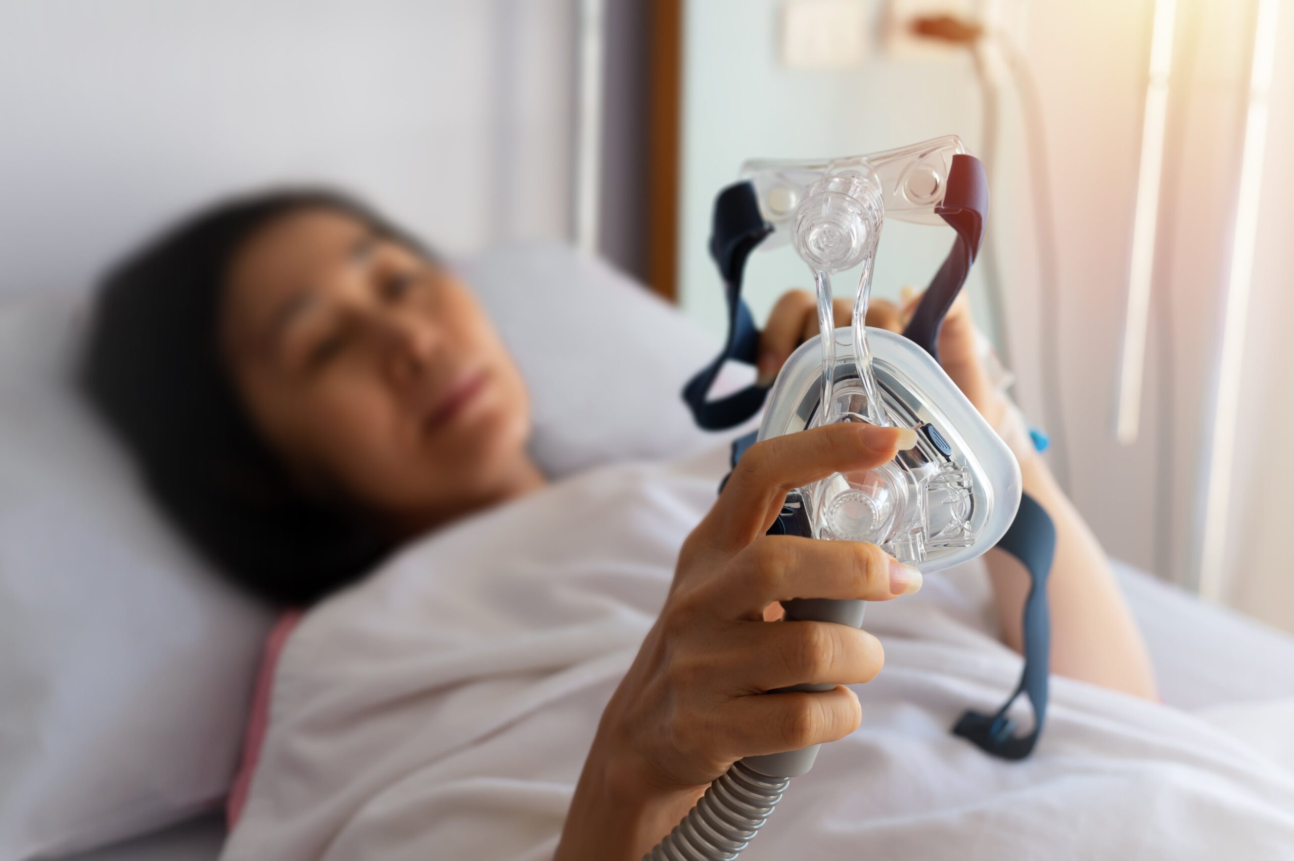 woman with sleep apnea using a CPAP