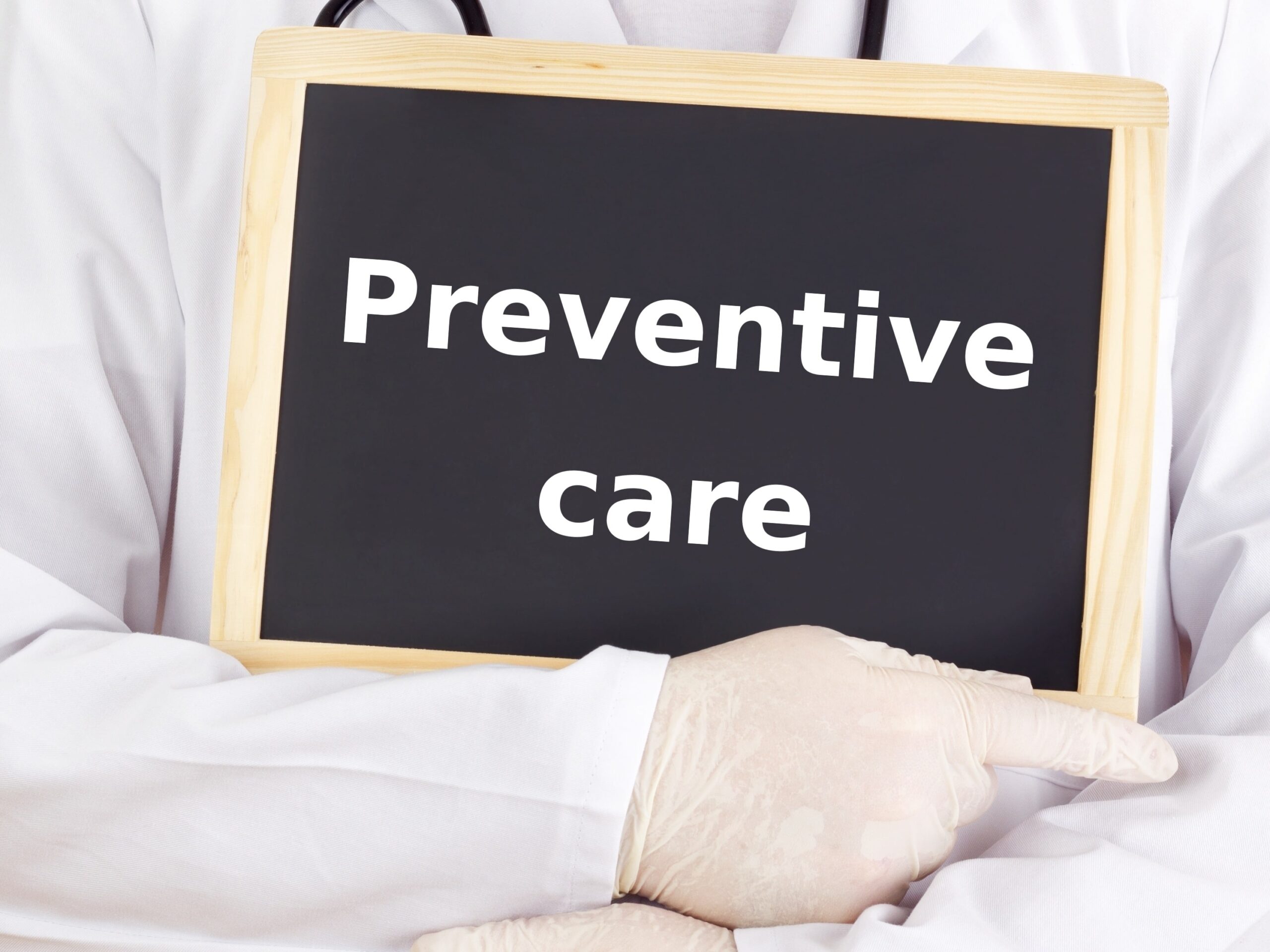 doctor holding a board that says preventive care