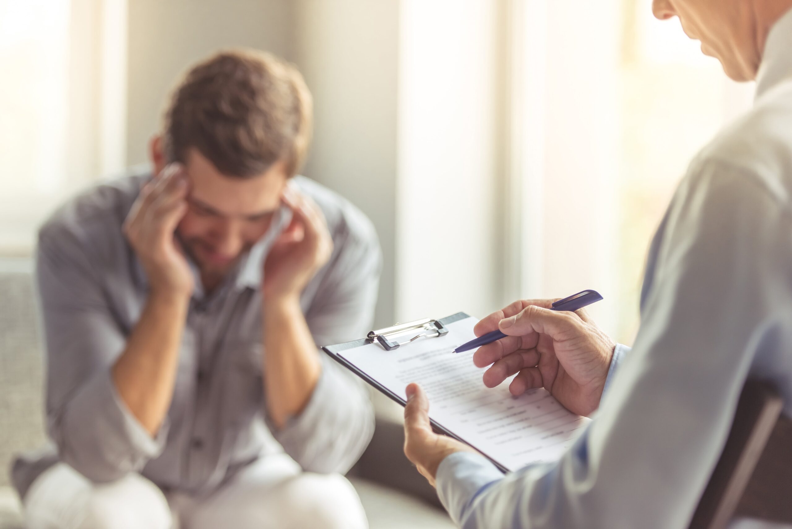 man with mental health issues talking with therapist